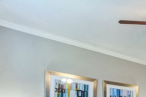 Large Living Room with open concept kitchen and ceiling fan and hard wood floors